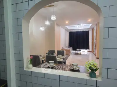 Charming open-layout living room with elegant dining area and cozy seating, perfect for modern living.