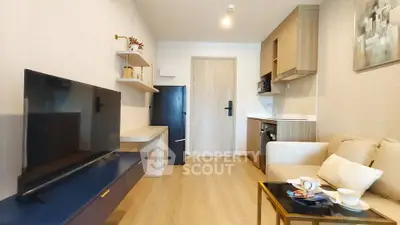 Modern living room with sleek furniture and compact kitchen area, perfect for urban living.