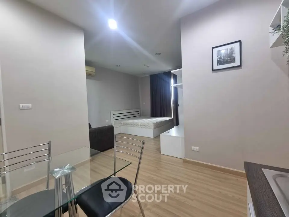 Modern studio apartment with sleek design and open layout, featuring a cozy living area and stylish furnishings.