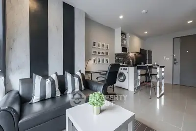 Modern living room with stylish decor and integrated kitchen appliances