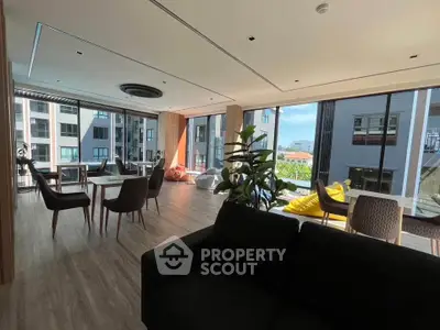 Spacious modern living room with large windows and stylish furniture