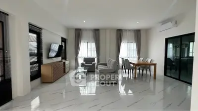 Spacious modern living room with elegant decor and ample natural light.