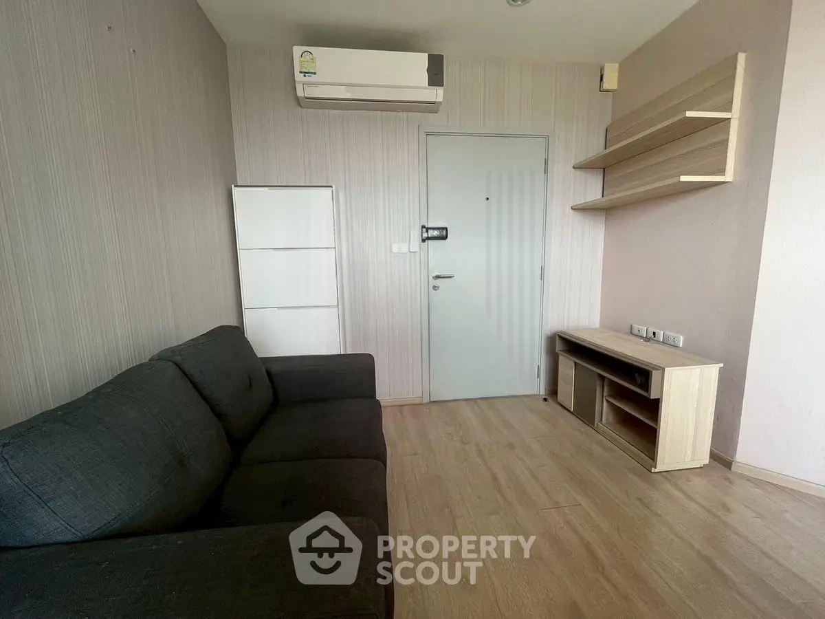 Modern living room with sleek furniture and air conditioning in a stylish apartment.