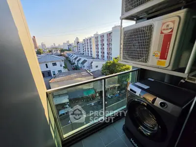 Modern balcony with city view and laundry appliances, perfect for urban living.