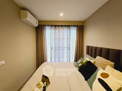 Cozy bedroom with modern decor and large window for natural light