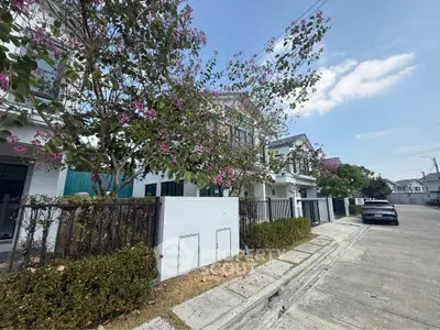 Charming suburban street with modern townhouses and blooming trees