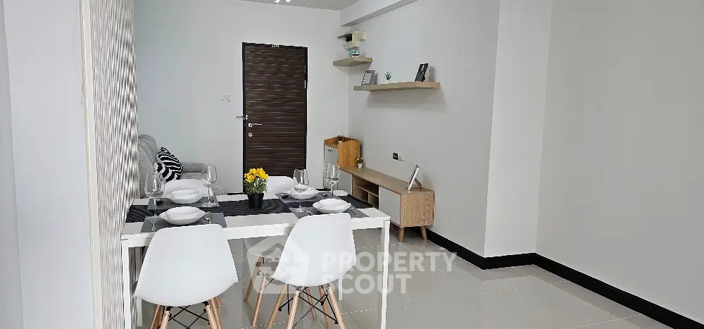 Modern dining area with stylish white chairs and minimalist decor