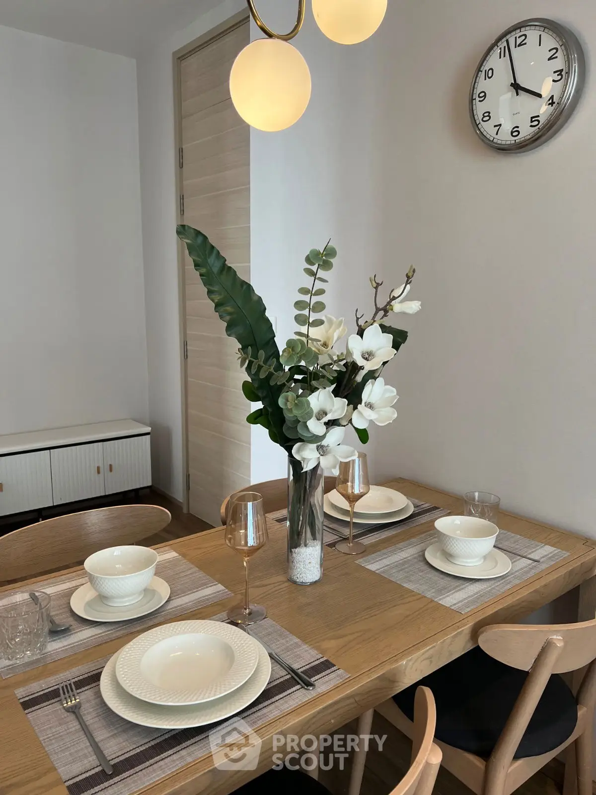 Elegant dining area with modern decor and stylish table setting.