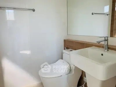Modern bathroom with sleek fixtures and large mirror