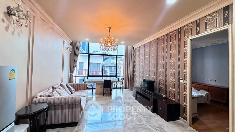 Luxurious living room with elegant chandelier and stylish decor, featuring a spacious layout and modern furnishings.