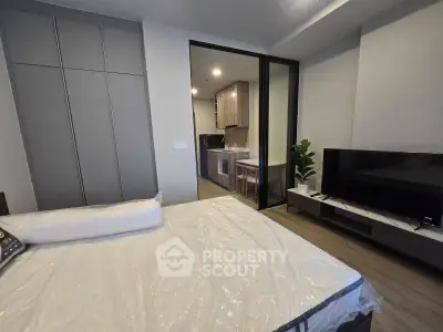 Modern studio apartment with sleek kitchen and cozy living area, perfect for urban living.