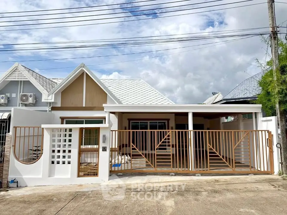Charming single-story house with modern design and spacious gated driveway.