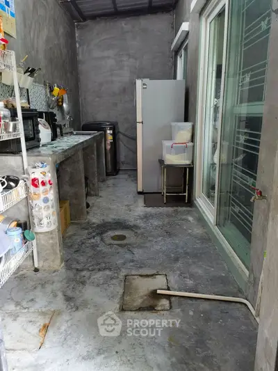 Functional kitchen with concrete flooring and modern appliances