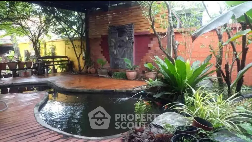 Charming garden with koi pond and lush greenery, perfect for tranquil outdoor living.