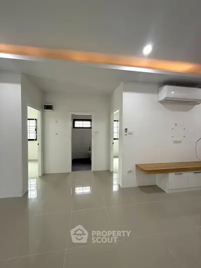 Spacious modern interior with sleek flooring and air conditioning, ideal for comfortable living.