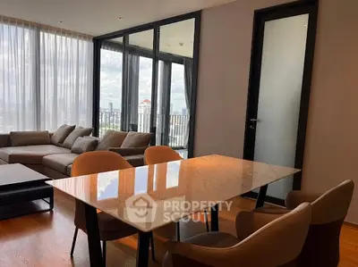 Luxurious modern living room with city view and elegant dining area.
