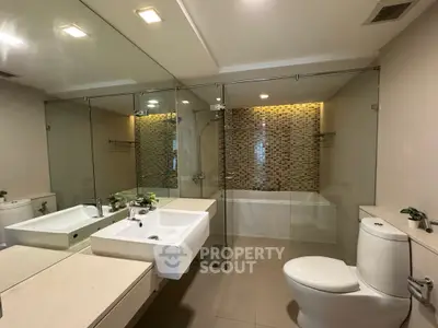 Modern bathroom with glass shower and elegant tile design