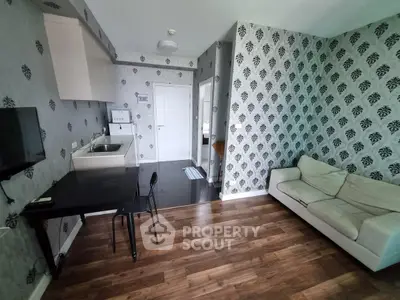 Modern living room with stylish wallpaper and compact kitchen area