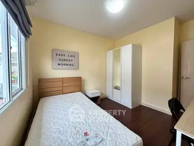 Cozy bedroom with minimalist decor and ample natural light