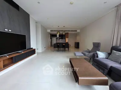 Spacious modern living room with sleek furniture and open kitchen layout