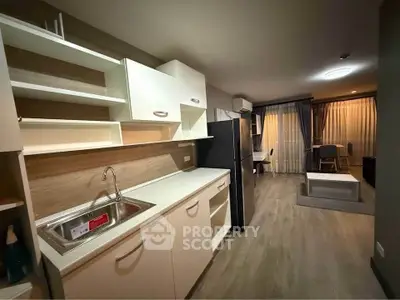 Modern open-layout kitchen with sleek cabinets and spacious living area