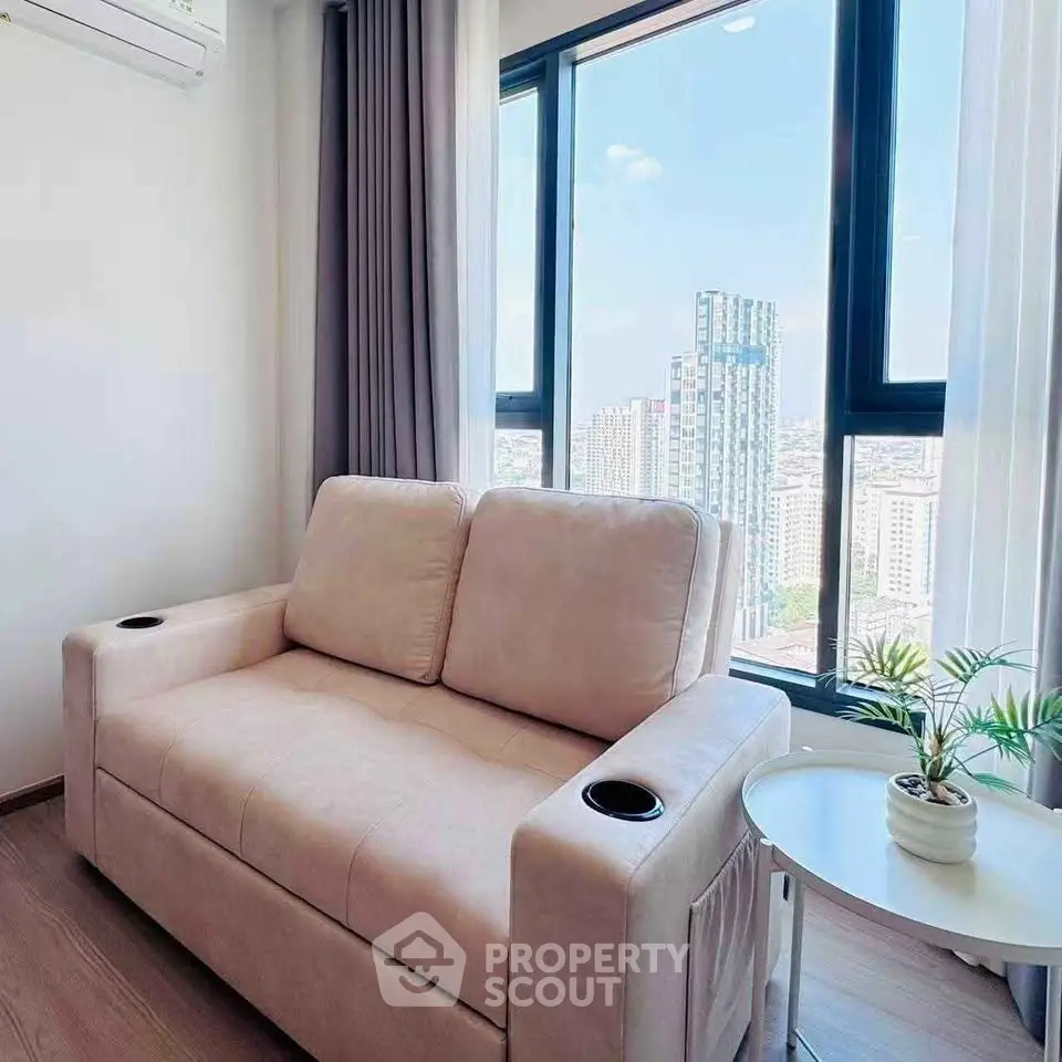 Modern living room with cozy sofa and stunning city view through large windows.