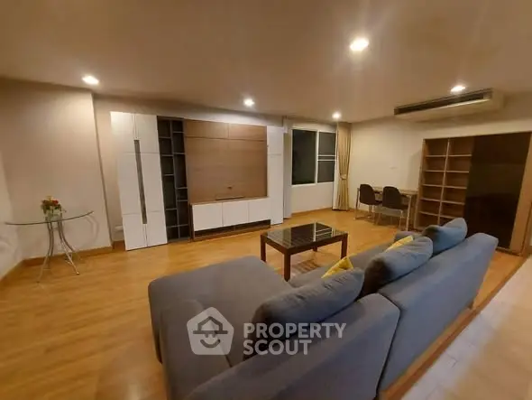 Spacious modern living room with stylish furniture and wooden flooring