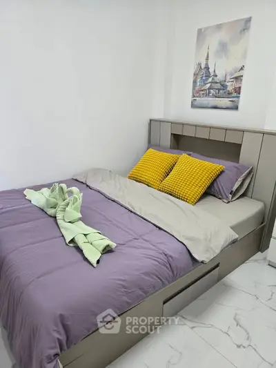Cozy bedroom with modern decor and vibrant pillows, perfect for relaxation.