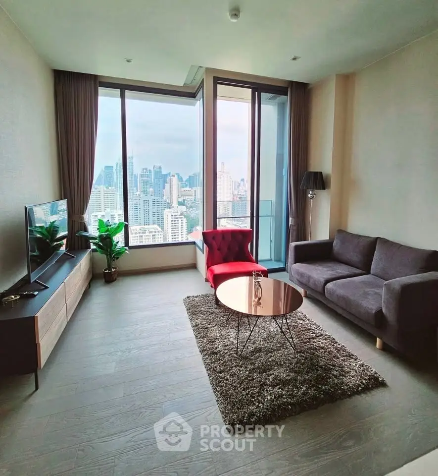 Modern living room with city view, stylish furniture, and large windows in high-rise apartment.