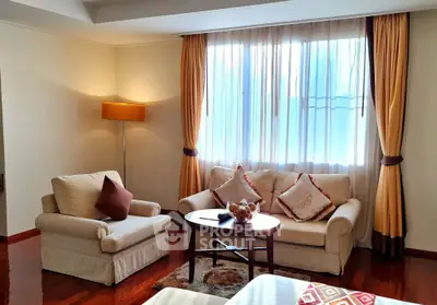 Cozy living room with elegant sofa set and warm lighting, perfect for relaxation.