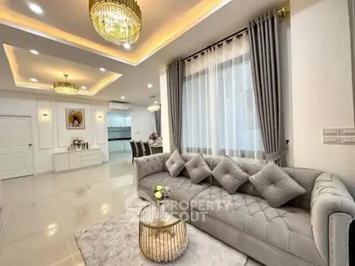 Luxurious living room with elegant decor and modern lighting in a spacious open layout.