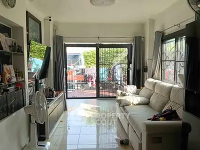 Spacious living room with sliding glass doors leading to a sunny patio.