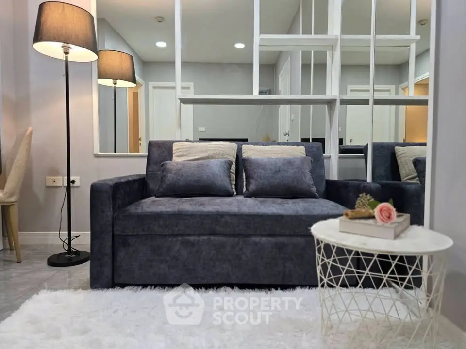 Modern living room with stylish sofa and elegant decor in a cozy apartment setting.