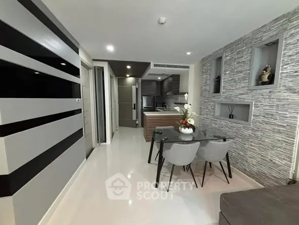 Modern open-plan living and dining area with stylish decor and sleek kitchen design.