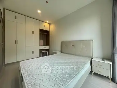 Spacious bedroom with modern furnishings and ample storage space