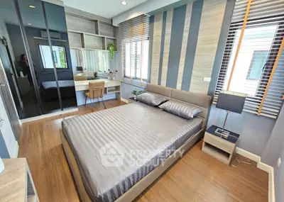 Modern bedroom with stylish decor and ample natural light