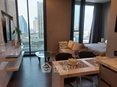 Modern studio apartment with city view, open living and dining area, and large windows.