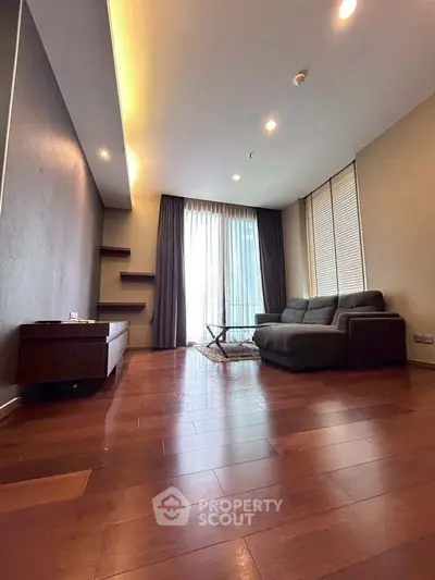 Spacious modern living room with wooden flooring and elegant furniture