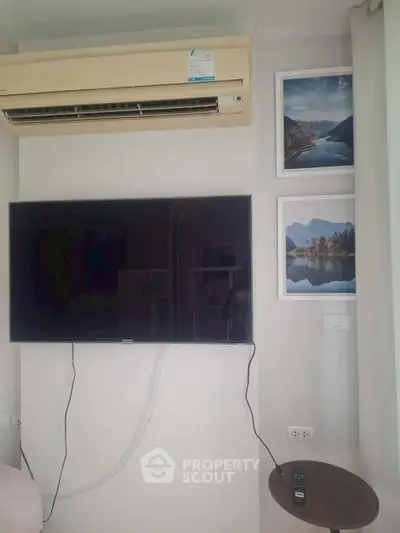 Modern living room with wall-mounted TV and air conditioning unit