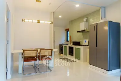 Modern kitchen with sleek appliances and stylish dining area