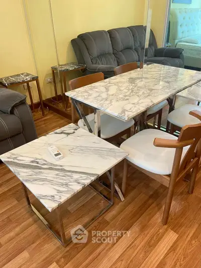 Stylish living room with marble table and modern furniture on wooden flooring.