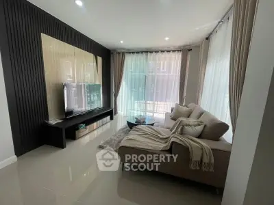 Modern living room with sleek design, large windows, and cozy sectional sofa.