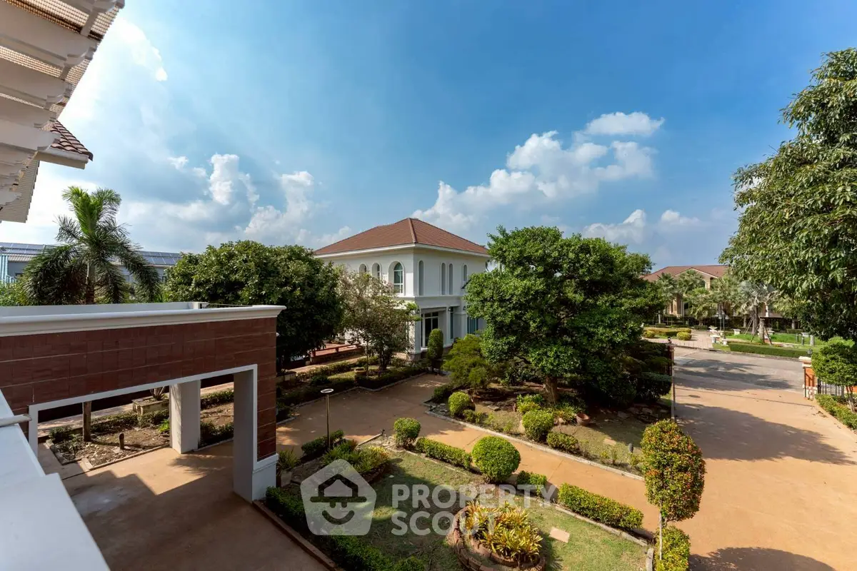 Luxurious villa with lush garden and clear blue sky view
