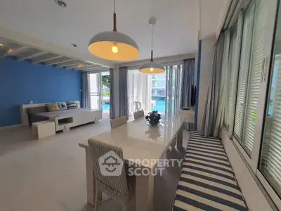 Spacious living room with pool view and modern decor