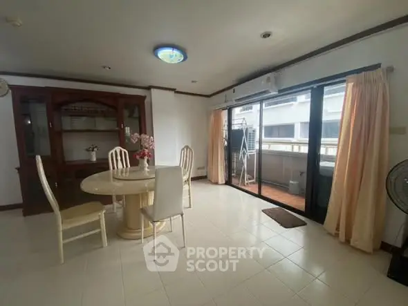 Spacious dining area with balcony access in modern apartment