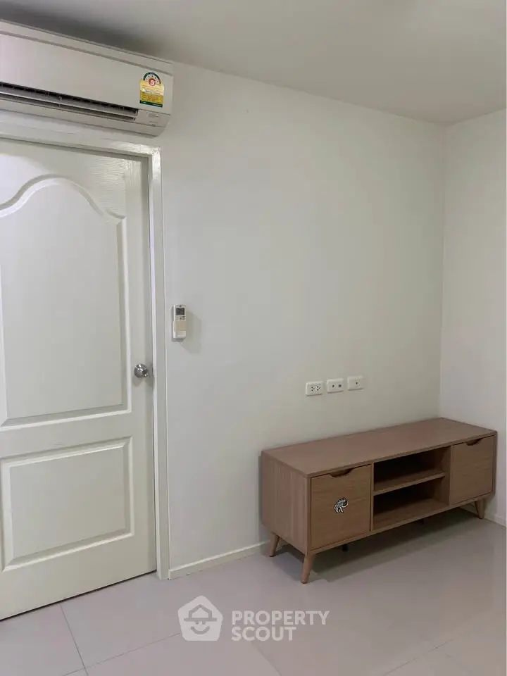 Modern interior with air conditioning and stylish wooden cabinet in a bright room.