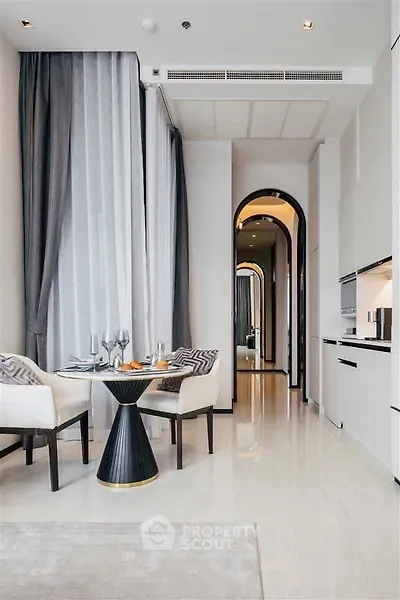 Luxurious modern dining area with high ceilings and elegant decor in a stylish apartment.
