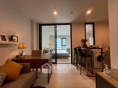 Modern open-plan living room with kitchen and bedroom in a stylish apartment