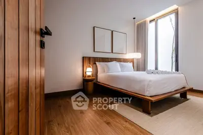 Modern bedroom with wooden flooring and stylish decor