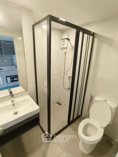 Modern bathroom with glass shower enclosure and sleek fixtures